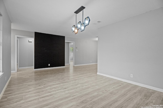 7626 Westfield, San Antonio, TX 78227 - unfurnished living room with light wood-style flooring, baseboards, and a chandelier