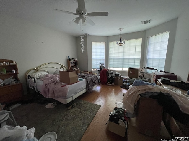 19102 Weeping Oak, Spring, TX 77388 - bedroom with wood finished floors, a chandelier, and a ceiling fan