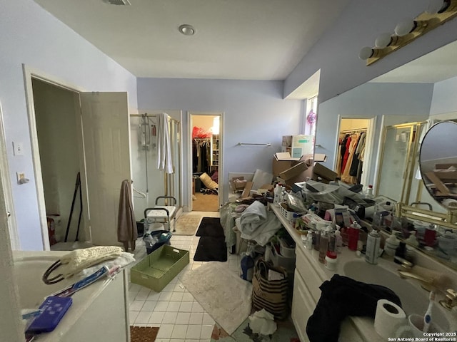 19102 Weeping Oak, Spring, TX 77388 - full bathroom featuring a shower stall, a spacious closet, tile patterned floors, and vanity