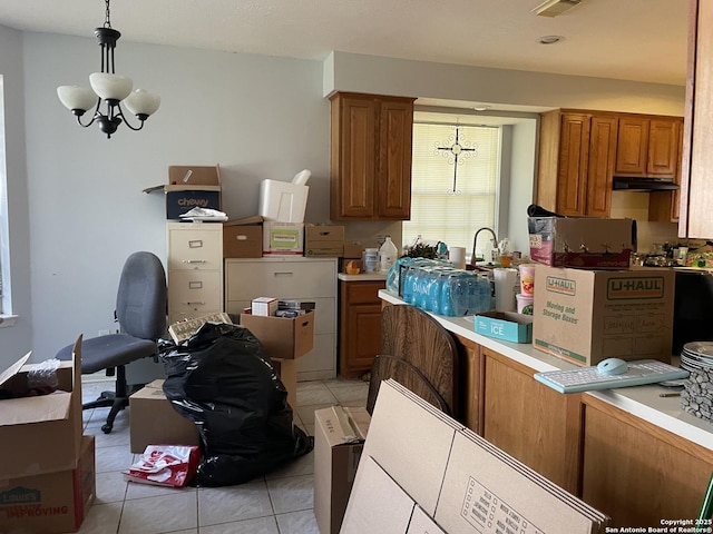 19102 Weeping Oak, Spring, TX 77388 - kitchen featuring a chandelier, brown cabinetry, light tile patterned floors, pendant lighting, and light countertops