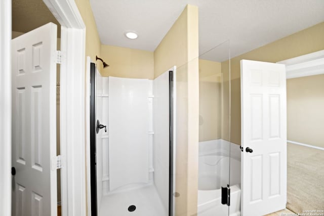 445 Auburn Park, Schertz, TX 78154 - bathroom featuring a stall shower, a bath, and baseboards