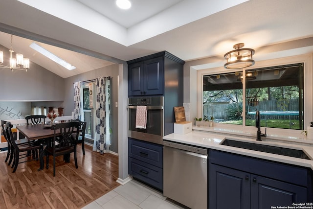 2930 Low Oak St, San Antonio, TX 78232 - kitchen featuring stainless steel appliances, a sink, a skylight, light countertops, and a chandelier
