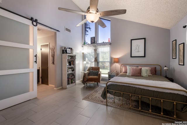 2930 Low Oak St, San Antonio, TX 78232 - bedroom featuring high vaulted ceiling, a barn door, a ceiling fan, and a textured ceiling