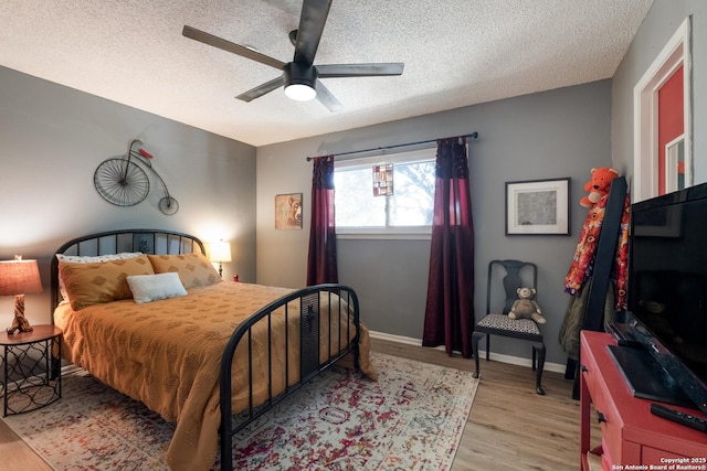 2930 Low Oak St, San Antonio, TX 78232 - bedroom featuring a textured ceiling, wood finished floors, ceiling fan, and baseboards