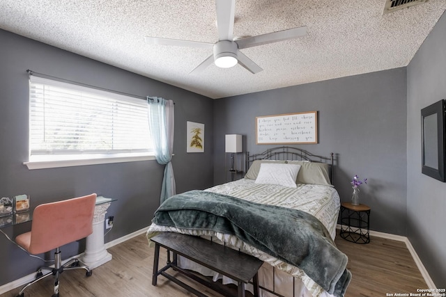 2930 Low Oak St, San Antonio, TX 78232 - bedroom featuring a textured ceiling, wood finished floors, ceiling fan, and baseboards