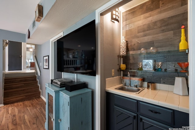 2930 Low Oak St, San Antonio, TX 78232 - living room with wet bar, wood finished floors, stairs, and baseboards