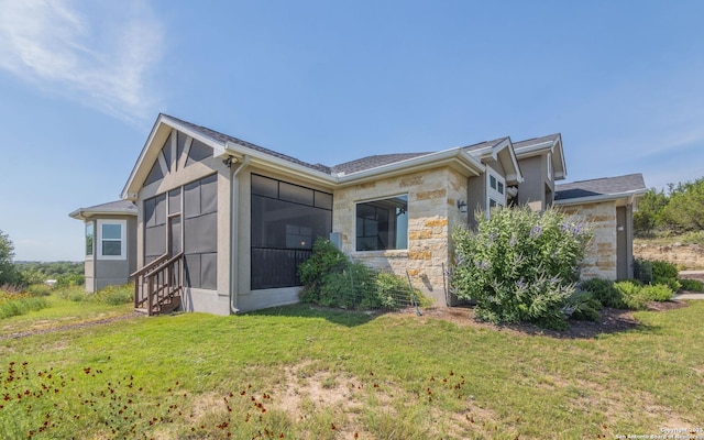 22793 N Cranes Mill Rd, Canyon Lake, TX 78133 - view of side of home featuring stone siding, a sunroom, and a lawn