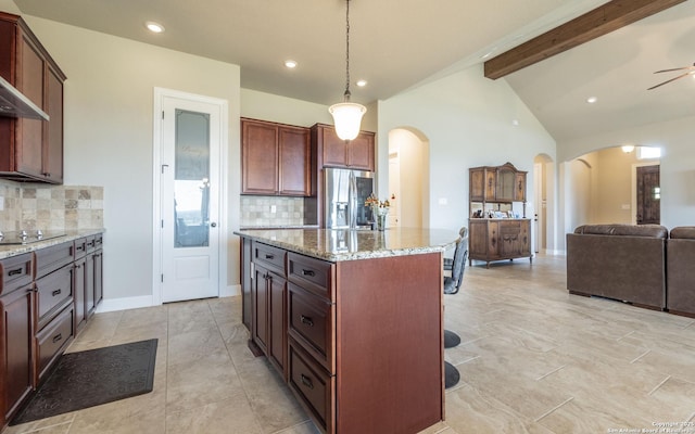 22793 N Cranes Mill Rd, Canyon Lake, TX 78133 - kitchen with arched walkways, stainless steel refrigerator with ice dispenser, tasteful backsplash, open floor plan, and recessed lighting