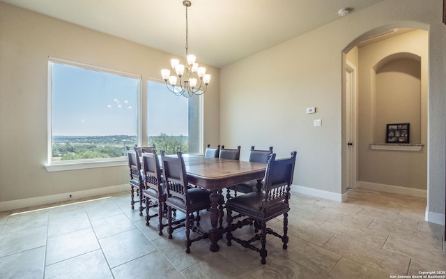 22793 N Cranes Mill Rd, Canyon Lake, TX 78133 - dining space featuring arched walkways, a chandelier, baseboards, and light tile patterned floors