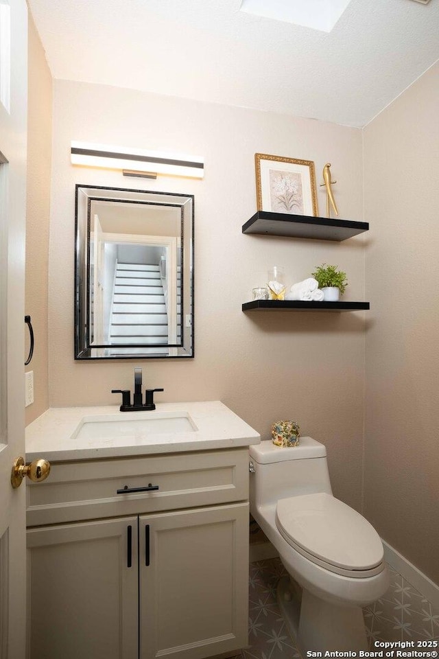 12006 Vista Nogal Unit 3A, San Antonio, TX 78213 - half bathroom with toilet, vanity, and baseboards