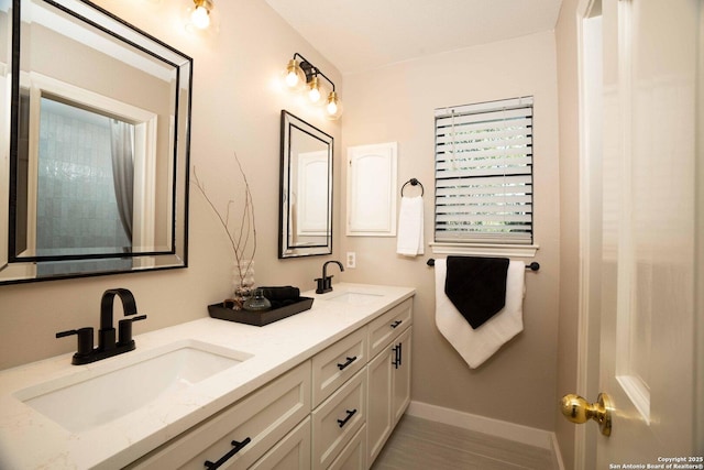 12006 Vista Nogal Unit 3A, San Antonio, TX 78213 - bathroom featuring double vanity and baseboards