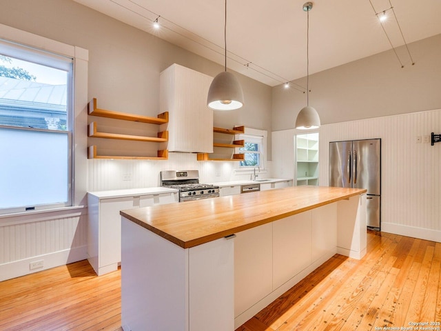 302 Cedar, San Antonio, TX 78210 - kitchen featuring appliances with stainless steel finishes, wood counters, open shelves, light wood-type flooring, and a towering ceiling