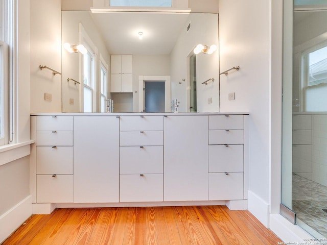 302 Cedar, San Antonio, TX 78210 - bathroom featuring wood finished floors, vanity, and baseboards