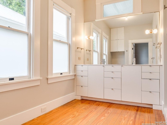 302 Cedar, San Antonio, TX 78210 - bathroom with wood finished floors, baseboards, plenty of natural light, and vanity