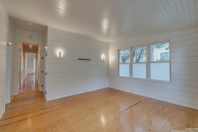 302 Cedar, San Antonio, TX 78210 - spare room with light wood finished floors, wooden walls, and wooden ceiling