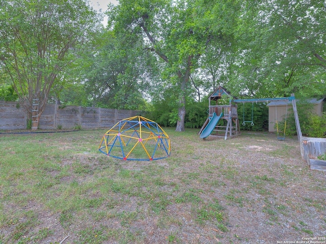 302 Cedar, San Antonio, TX 78210 - view of yard featuring a playground, fence, a shed, and an outbuilding