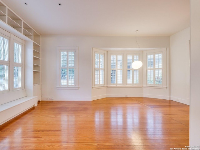 302 Cedar, San Antonio, TX 78210 - unfurnished room featuring light wood finished floors, baseboards, and built in shelves