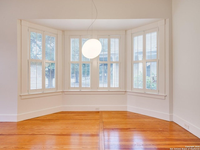302 Cedar, San Antonio, TX 78210 - unfurnished dining area featuring light wood-type flooring, plenty of natural light, and baseboards
