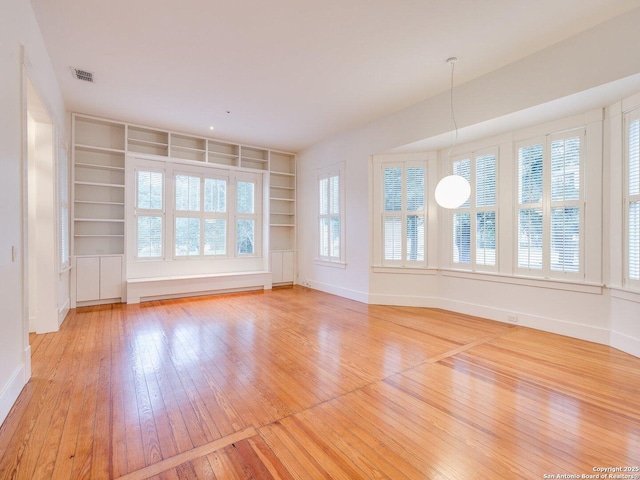 302 Cedar, San Antonio, TX 78210 - empty room featuring light wood-type flooring, built in features, and baseboards