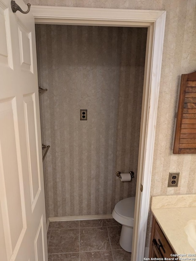 6410 Firestone, San Antonio, TX 78244 - bathroom with vanity, toilet, and baseboards