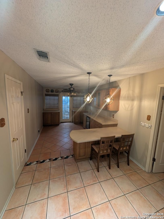 6410 Firestone, San Antonio, TX 78244 - dining area featuring light tile patterned floors, baseboards, and a textured ceiling