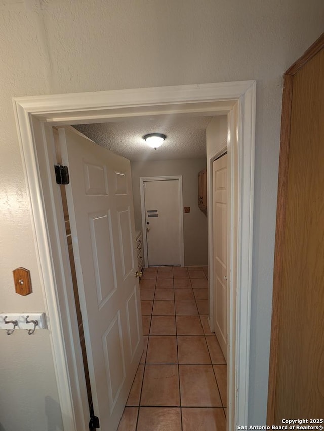 6410 Firestone, San Antonio, TX 78244 - corridor featuring light tile patterned floors and a textured ceiling