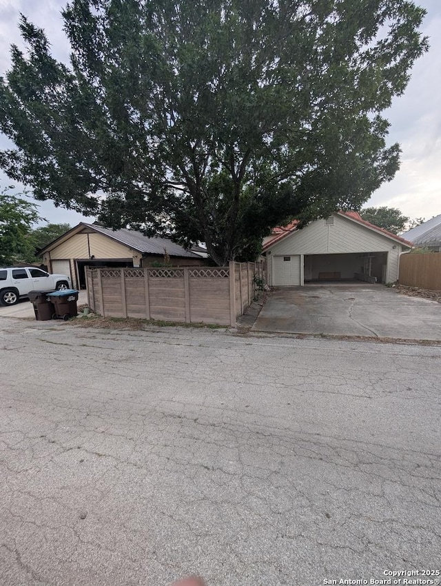 6410 Firestone, San Antonio, TX 78244 - view of side of home with fence and an outbuilding