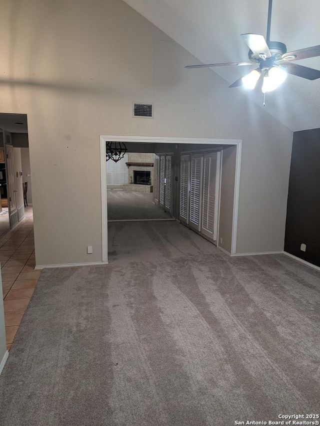 6410 Firestone, San Antonio, TX 78244 - carpeted empty room featuring a ceiling fan, a fireplace, baseboards, and high vaulted ceiling
