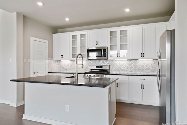 12414 Mineshaft, San Antonio, TX 78254 - kitchen featuring appliances with stainless steel finishes, dark countertops, dark wood-style flooring, tasteful backsplash, and recessed lighting