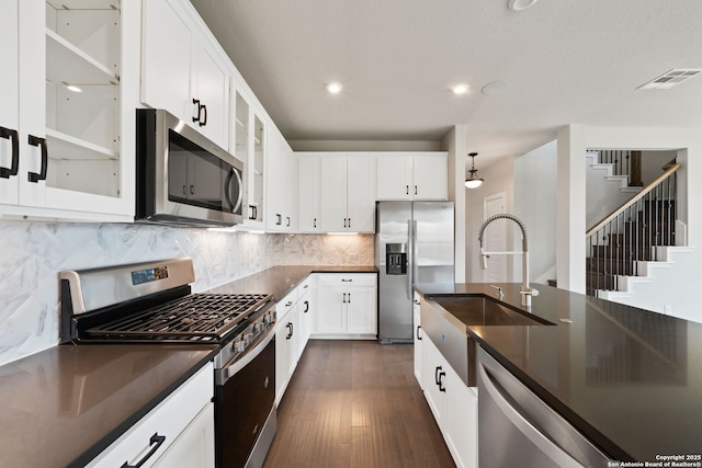 12414 Mineshaft, San Antonio, TX 78254 - kitchen with appliances with stainless steel finishes, dark countertops, a sink, dark wood-style flooring, and recessed lighting