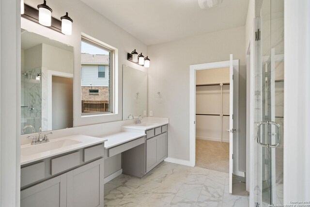 12414 Mineshaft, San Antonio, TX 78254 - full bathroom featuring a stall shower, marble finish floors, a walk in closet, baseboards, and vanity