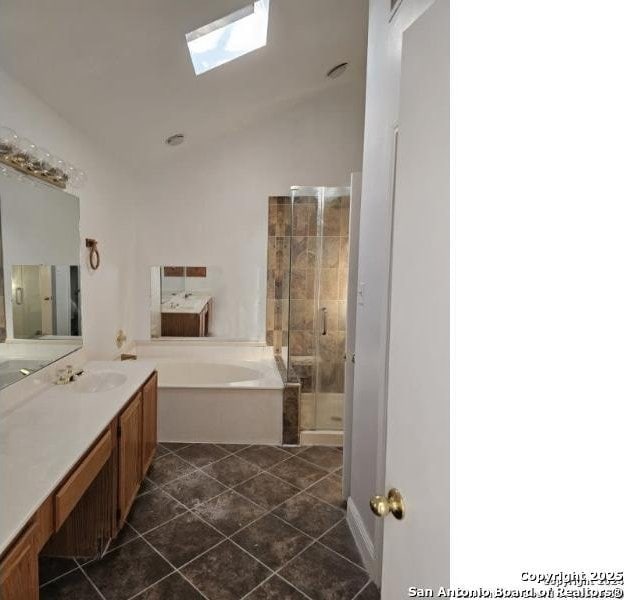 4614 Acacia Woods, San Antonio, TX 78249 - bathroom with a skylight, tile patterned floors, a shower stall, a bath, and vanity