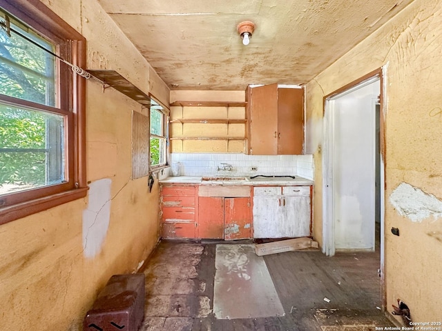 235 Notre Dame, San Antonio, TX 78228 - kitchen featuring open shelves, light countertops, decorative backsplash, dark wood-style flooring, and a sink