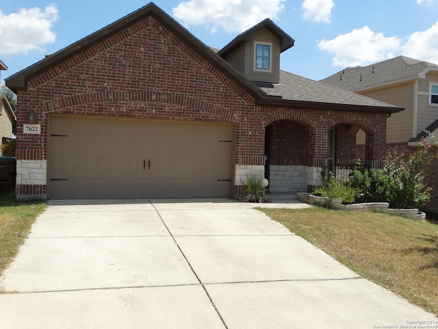 7622 Ruger Rnch, San Antonio, TX 78254 - view of front of house with brick siding, driveway, roof with shingles, and a garage