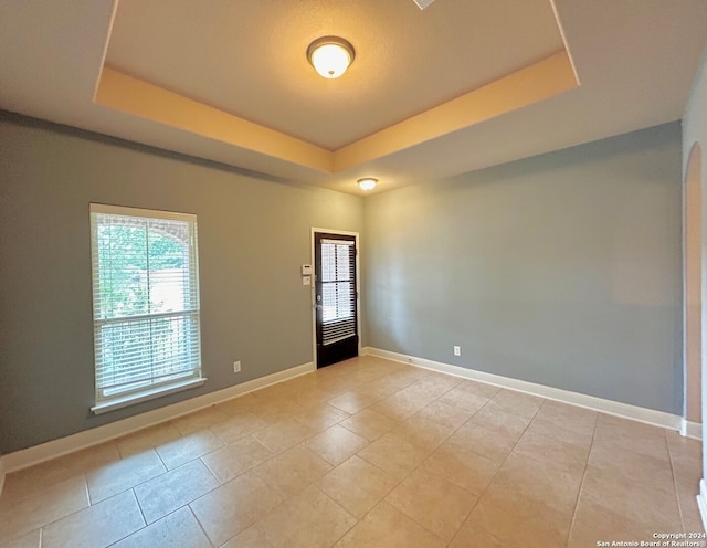7622 Ruger Rnch, San Antonio, TX 78254 - spare room featuring a raised ceiling, baseboards, and light tile patterned floors