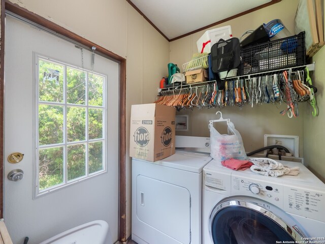 15411 Cranes Mill Rd, Canyon Lake, TX 78133 - laundry area with washing machine and dryer and ornamental molding