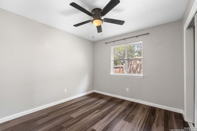 6909 Quail Lk, San Antonio, TX 78244 - empty room with dark wood-type flooring, baseboards, and ceiling fan