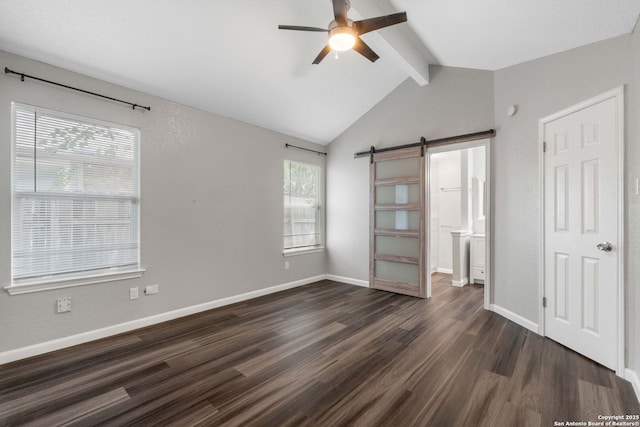 6909 Quail Lk, San Antonio, TX 78244 - unfurnished bedroom featuring a barn door, dark wood-style floors, baseboards, and connected bathroom