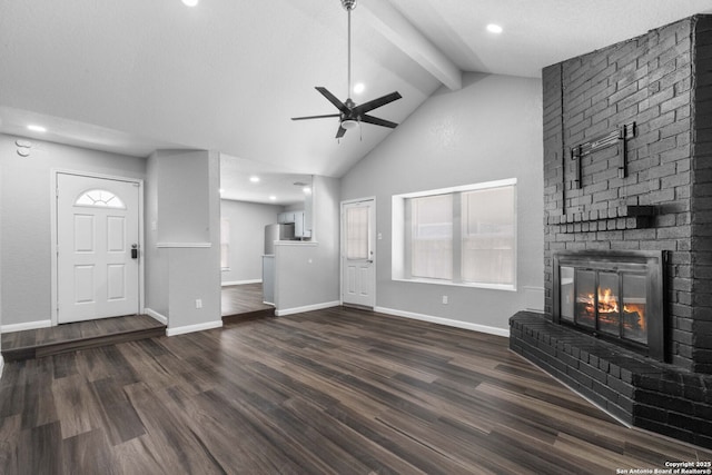 6909 Quail Lk, San Antonio, TX 78244 - unfurnished living room with a ceiling fan, beamed ceiling, a brick fireplace, dark wood-style flooring, and baseboards