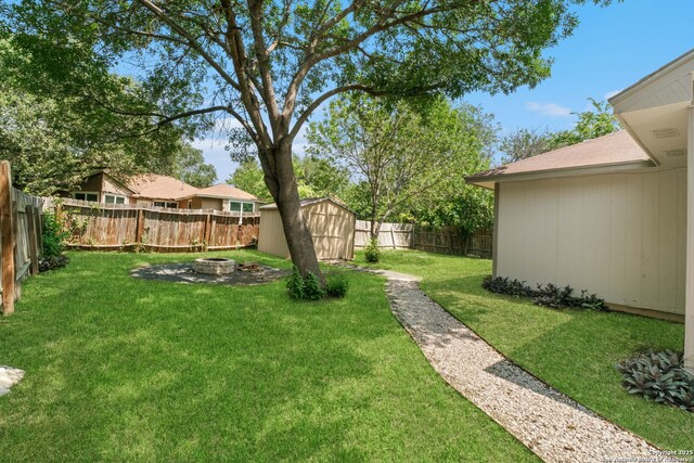 6909 Quail Lk, San Antonio, TX 78244 - view of yard featuring a shed, an outbuilding, and an outdoor fire pit