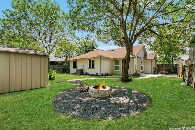 6909 Quail Lk, San Antonio, TX 78244 - rear view of house with central AC, an outdoor fire pit, an outdoor structure, a shed, and a patio