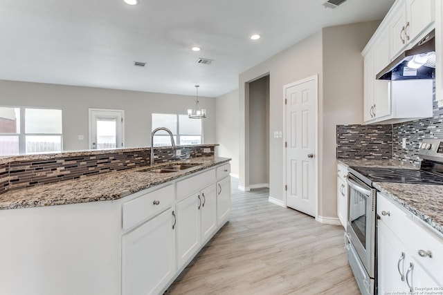 13508 Cranbrook, Live Oak, TX 78233 - kitchen with electric stove, a sink, under cabinet range hood, a chandelier, and light stone counters