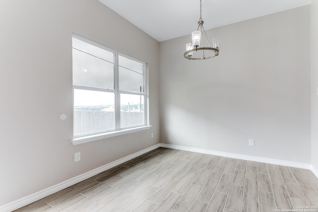 13508 Cranbrook, Live Oak, TX 78233 - unfurnished room with a chandelier, light wood-style floors, and baseboards