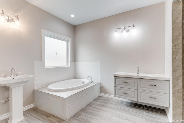 13508 Cranbrook, Live Oak, TX 78233 - bathroom with a sink, baseboards, wood finish floors, and a bath