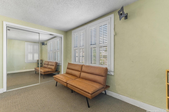 1605 W Winnipeg, San Antonio, TX 78225 - living area with carpet floors, a textured ceiling, and baseboards