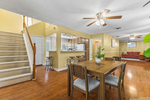 1605 W Winnipeg, San Antonio, TX 78225 - dining space featuring a ceiling fan, stairway, wood finished floors, and a textured ceiling