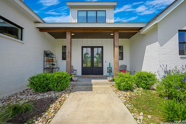 340 Warbler, Spring Branch, TX 78070 - view of exterior entry with french doors, a porch, brick siding, and board and batten siding