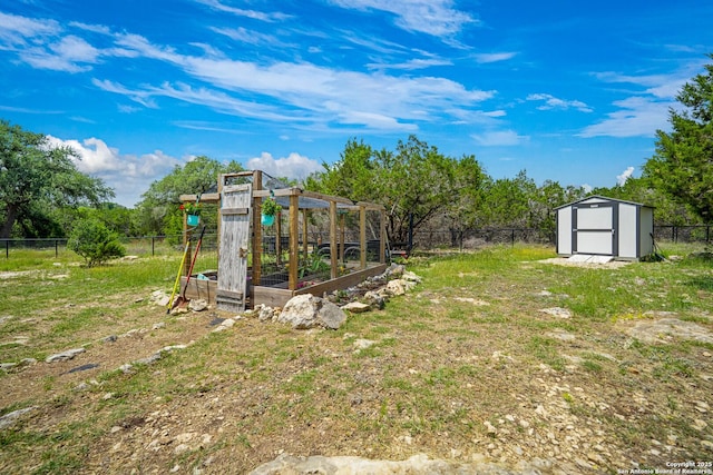 340 Warbler, Spring Branch, TX 78070 - fenced backyard featuring a vegetable garden, a storage unit, and an outdoor structure