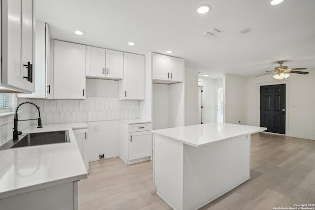 620 Euclid, San Antonio, TX 78212 - kitchen with tasteful backsplash, a ceiling fan, a kitchen island, white cabinets, and recessed lighting