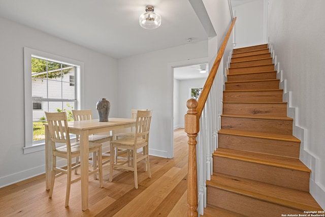 20505 Flat Creek Dr, Chandler, TX 75758 - dining area with light wood-style flooring, stairs, and baseboards